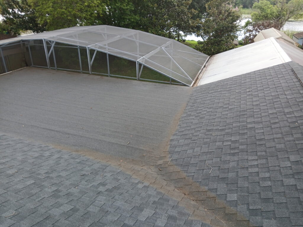 After roof cleaning around a screened enclosure with the roof surface cleaned