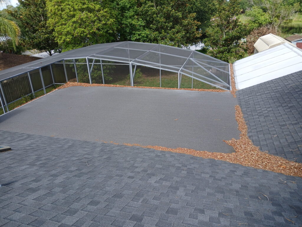 Before roof cleaning around a screened enclosure with debris on the roof surface