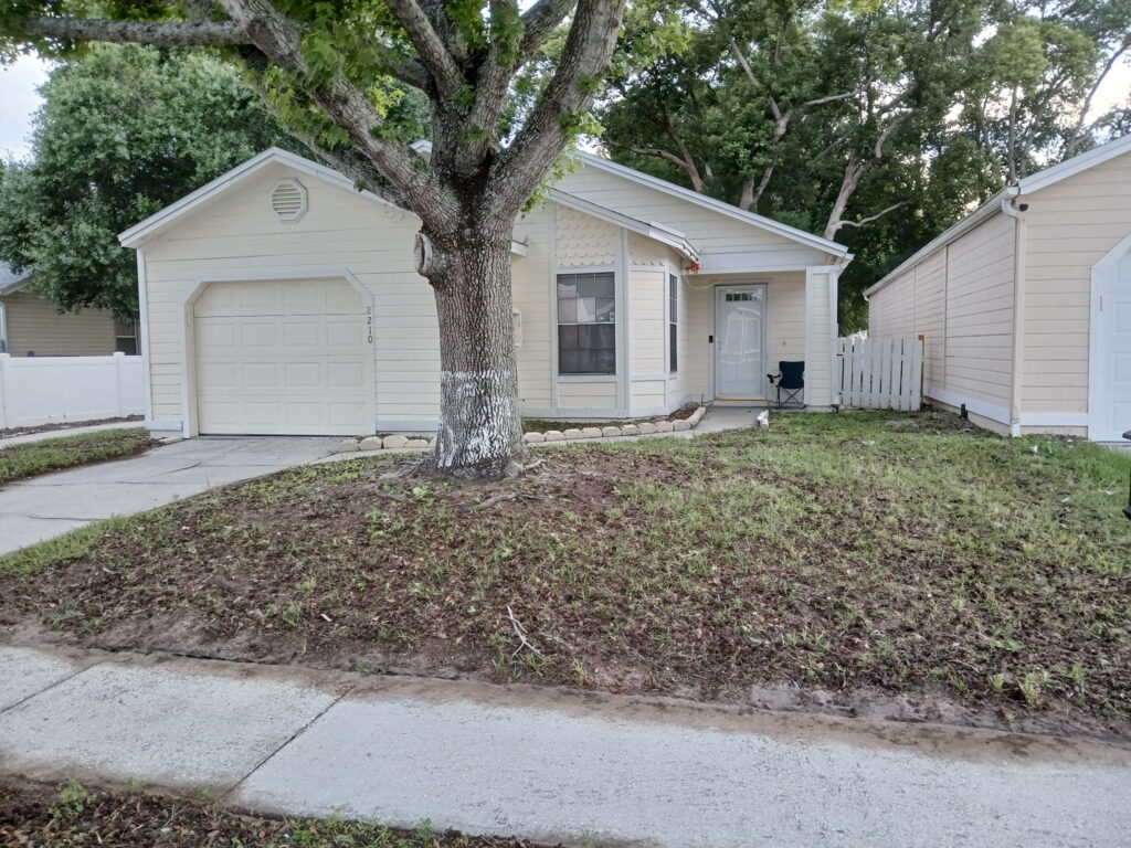 After front landscape cleanup with weeds removed and a cleaner entry area