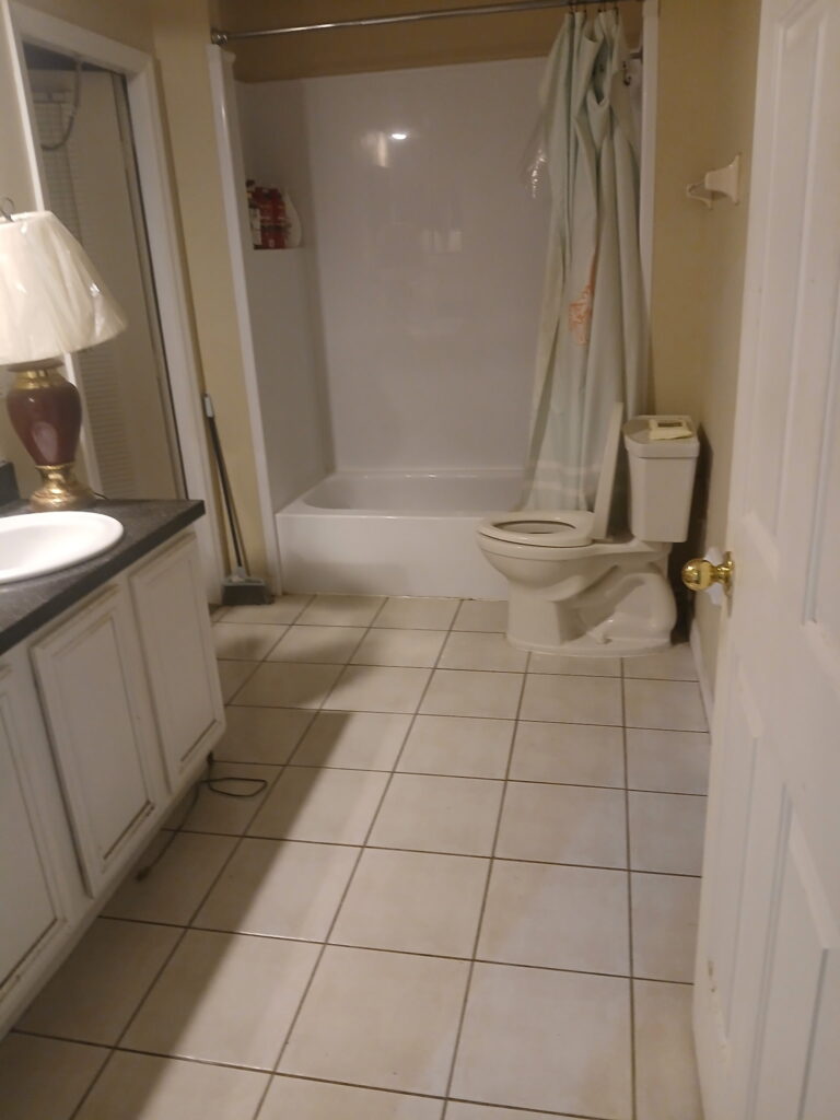 After bathroom cleaning and organization with clear floor space and cleaner surfaces