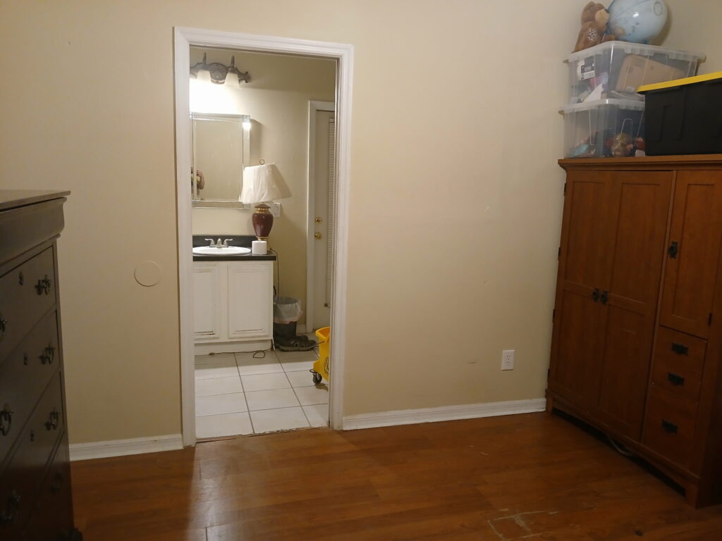 Bedroom cleaning and organization with furniture arranged and walkway cleared