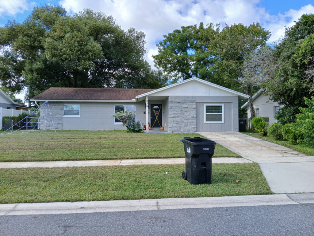 Clean exterior yard presentation with a maintained lawn and Central Florida home exterior